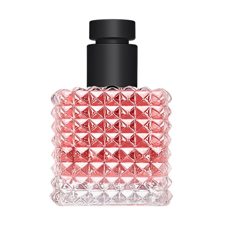 Textured pink perfume bottle on white background