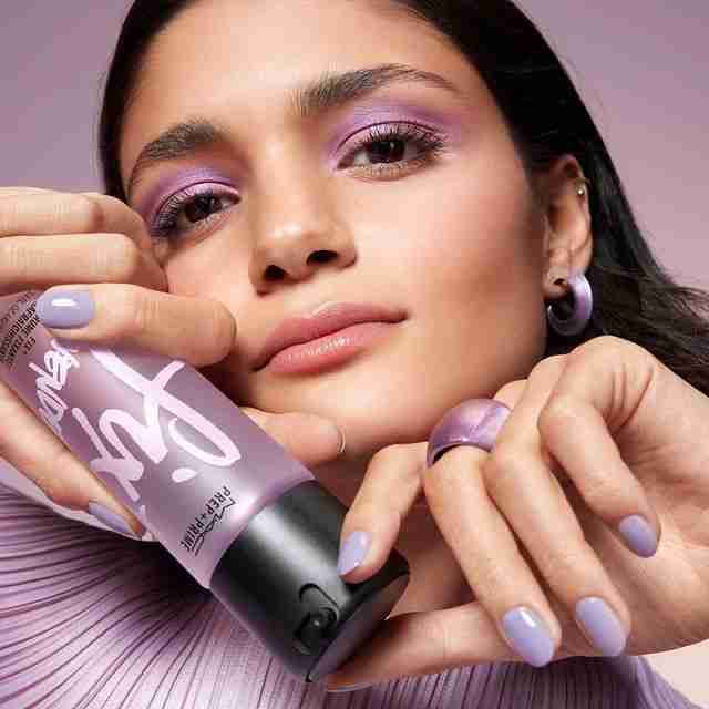 woman holding MAC Lavender Prep + Prime Fix + Spray bottle